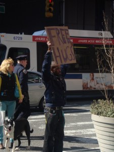 guy holding "free hugs" sign