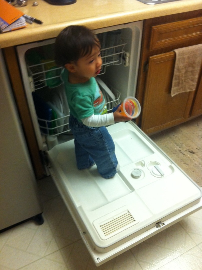 Baby in kitchen being wild