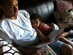 father and son reading a book