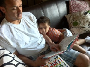reading daddy reading to son