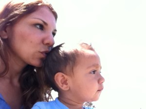 mom kisses son kiss on little boy's head