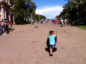 little boy pushes stroller pushing a stroller