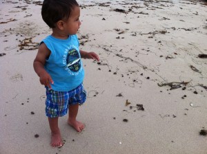 little boy on beach sand