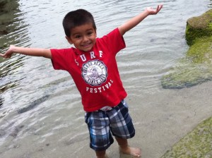 little boy with arms open accomplishment