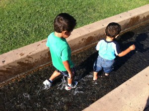 boys playing in water boys walking