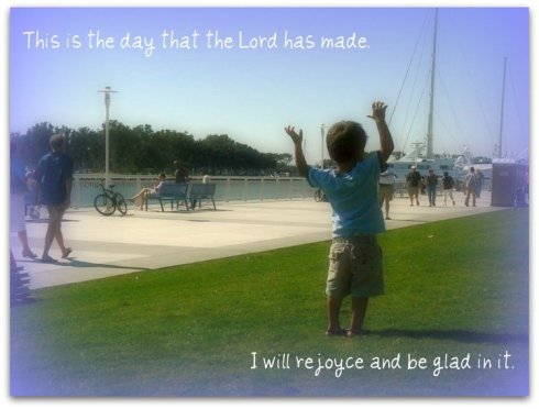 praise boy with arms up